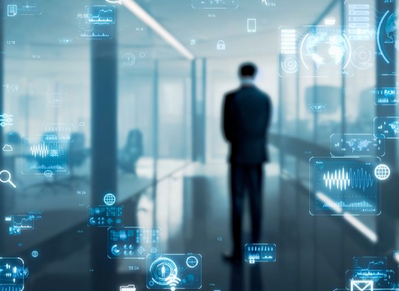 デジタルデータが浮かぶように表示されたオフィス空間で立ち止まるビジネスパーソンのシルエット